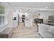 Open-concept living space with a modern kitchen, stainless steel appliances, and ample natural light perfect for entertaining at 5219 Farmbrook Dr, Charlotte, NC 28210