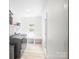 Bright laundry room features modern washer and dryer, shiplap accent wall, and ample storage space at 5219 Farmbrook Dr, Charlotte, NC 28210