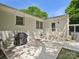 This backyard patio features a grill, exterior door, and well-maintained landscaping at 5219 Farmbrook Dr, Charlotte, NC 28210