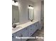 Elegant bathroom boasts double vanity with white countertops and dark fixtures adding a touch of luxury at 6209 Busch Way, Midland, NC 28107