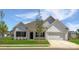 Charming single-story home with white siding, black shutters, a well-manicured lawn, and an attached two-car garage at 6209 Busch Way, Midland, NC 28107