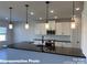 Modern kitchen with sleek black countertops, pendant lighting, and contemporary cabinetry at 6209 Busch Way, Midland, NC 28107