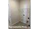 Bright laundry room equipped with wire shelving and utility connections for modern appliances at 6209 Busch Way, Midland, NC 28107