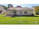 Rear exterior of the home showing a patio and well-manicured lawn at 6724 Long Nook Ln, Indian Trail, NC 28079
