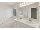 Bright bathroom features a double vanity, large mirror, and a separate soaking tub at 6724 Long Nook Ln, Indian Trail, NC 28079