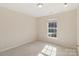 Inviting bedroom featuring a window for natural light and neutral carpeting at 6724 Long Nook Ln, Indian Trail, NC 28079