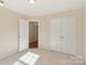 Bedroom with double closets and a view into the hallway with hardwood flooring at 6724 Long Nook Ln, Indian Trail, NC 28079