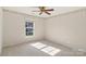 Bright bedroom featuring neutral walls with floral border, a ceiling fan, and natural light from a window at 6724 Long Nook Ln, Indian Trail, NC 28079