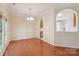 Dining area featuring hardwood floors, crown molding, and pass through to kitchen at 6724 Long Nook Ln, Indian Trail, NC 28079