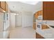 Bright kitchen featuring wood cabinets, white appliances, and a skylight providing natural light at 6724 Long Nook Ln, Indian Trail, NC 28079
