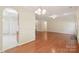 Open-concept living space with hardwood floors and archway to kitchen at 6724 Long Nook Ln, Indian Trail, NC 28079