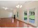 Open concept living room with fireplace, hardwood floors, and access to backyard at 6724 Long Nook Ln, Indian Trail, NC 28079