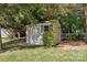 Charming storage shed nestled among trees in a well-maintained backyard at 6724 Long Nook Ln, Indian Trail, NC 28079