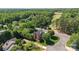 Aerial shot highlights this brick home nestled in a lush, green community with a nearby golf course at 7700 Ninth Fairway Ln, Mint Hill, NC 28227