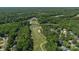 Breathtaking aerial view of a golf course community with lush greenery, serene ponds, and manicured fairways at 7700 Ninth Fairway Ln, Mint Hill, NC 28227