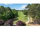 Scenic aerial view of lush golf course and surrounding trees at 7700 Ninth Fairway Ln, Mint Hill, NC 28227