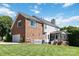 Expansive backyard featuring a well-manicured lawn and partial brick exterior at 7700 Ninth Fairway Ln, Mint Hill, NC 28227