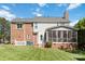 Spacious backyard with well-maintained lawn and screened-in porch view at 7700 Ninth Fairway Ln, Mint Hill, NC 28227