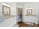 Dual sink bathroom with granite countertops, white cabinets, and an open view into the main bedroom at 7700 Ninth Fairway Ln, Mint Hill, NC 28227