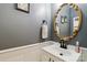 Elegant powder room features a decorative gold mirror and stylish sink at 7700 Ninth Fairway Ln, Mint Hill, NC 28227