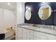 Bathroom with dual sinks, decorative mirrors, and a combined tub and shower at 7700 Ninth Fairway Ln, Mint Hill, NC 28227