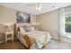 Comfortable bedroom featuring neutral colors and soft textures, and large bed with a yellow throw blanket at 7700 Ninth Fairway Ln, Mint Hill, NC 28227