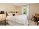 Cozy bedroom featuring a black wrought iron bed frame and a large window view at 7700 Ninth Fairway Ln, Mint Hill, NC 28227