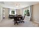 Large bonus room with windows, ceiling fan, seating, and game table at 7700 Ninth Fairway Ln, Mint Hill, NC 28227