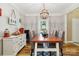 Charming dining room with a large wooden table, decorative lighting, and ample seating at 7700 Ninth Fairway Ln, Mint Hill, NC 28227