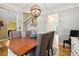 Charming dining room with a large wooden table, decorative lighting, and ample seating at 7700 Ninth Fairway Ln, Mint Hill, NC 28227