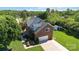 Charming two-story brick home featuring an attached garage, a well-manicured lawn, and mature landscaping at 7700 Ninth Fairway Ln, Mint Hill, NC 28227