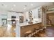 An inviting kitchen features white cabinetry, stainless steel appliances, and eat-in bar at 7700 Ninth Fairway Ln, Mint Hill, NC 28227
