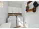 Bright laundry room with white cabinetry, washer, and dryer at 7700 Ninth Fairway Ln, Mint Hill, NC 28227