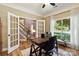 Bright office space with large window, desk, and beautiful hardwood floors at 7700 Ninth Fairway Ln, Mint Hill, NC 28227