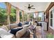 Inviting screened porch with ample seating and outdoor grill at 7700 Ninth Fairway Ln, Mint Hill, NC 28227