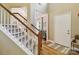 Staircase featuring wood railings and hardwood floors at 7700 Ninth Fairway Ln, Mint Hill, NC 28227