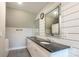 Bathroom boasts double sinks with a granite countertop, white shiplap and modern fixtures at 7740 Freeze Rd, Kannapolis, NC 28081