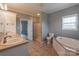 Bathroom featuring double sinks, a separate shower and a soaking tub with natural light at 7740 Freeze Rd, Kannapolis, NC 28081