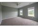 Spacious bedroom featuring neutral carpet and natural light from the windows providing an outdoor view at 7740 Freeze Rd, Kannapolis, NC 28081