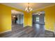 Elegant dining room with a chandelier and hardwood floors, flowing into other living spaces at 7740 Freeze Rd, Kannapolis, NC 28081