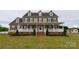 Charming two-story home with a welcoming front porch and well-manicured lawn at 7740 Freeze Rd, Kannapolis, NC 28081