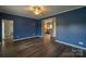 Stylish living room with hardwood floors and modern blue wall paint at 7740 Freeze Rd, Kannapolis, NC 28081