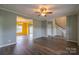 Open-concept living room showing hardwood floors and transitions to other rooms with bright natural light at 7740 Freeze Rd, Kannapolis, NC 28081