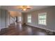 Open-concept living room with hardwood floors, fan, and bright windows offering ample natural light at 7740 Freeze Rd, Kannapolis, NC 28081