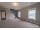 Upstairs loft area with carpeted floors and natural light from windows providing views of the backyard at 7740 Freeze Rd, Kannapolis, NC 28081