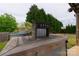 Outdoor bar area with beer taps, basketball court, and a serene backyard view at 7740 Freeze Rd, Kannapolis, NC 28081