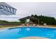 Sparkling in-ground pool with shaded lounge area, perfect for outdoor relaxation and entertainment at 7740 Freeze Rd, Kannapolis, NC 28081