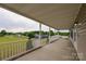 Spacious covered porch with white railings, concrete flooring, and scenic views at 7740 Freeze Rd, Kannapolis, NC 28081