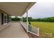 Inviting covered front porch featuring classic white railings and concrete flooring at 7740 Freeze Rd, Kannapolis, NC 28081