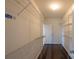 Walk-in closet featuring hardwood floors and metal shelving units for easy storage and organization at 7740 Freeze Rd, Kannapolis, NC 28081